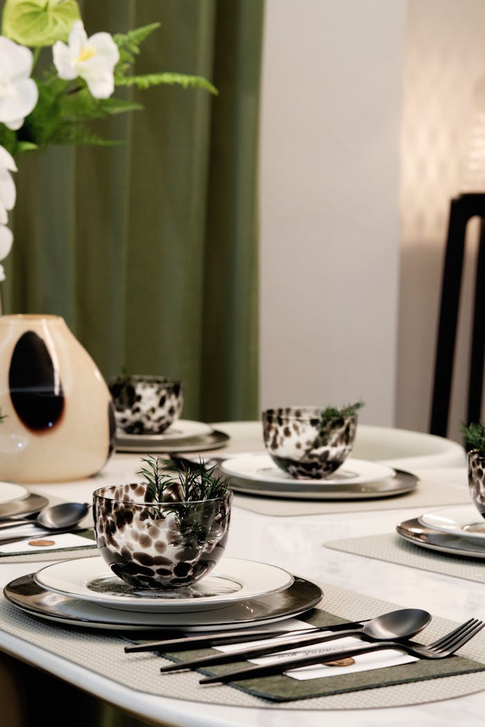 Stylish dining table arrangement with decorative bowls and elegant tableware.